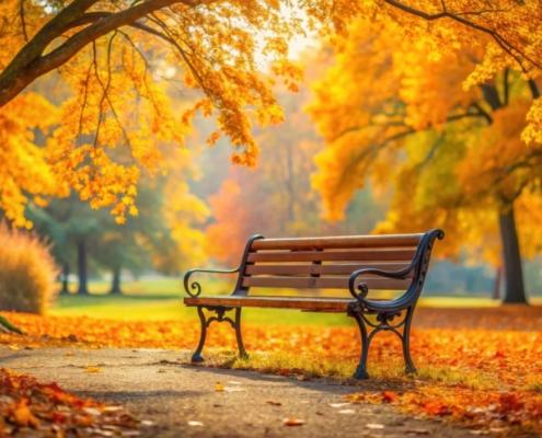 Eine elegante Parkbank unter einem Baum mit leuchtend gelben Herbstblättern. Perfekter Ort zum Entspannen in der Natur